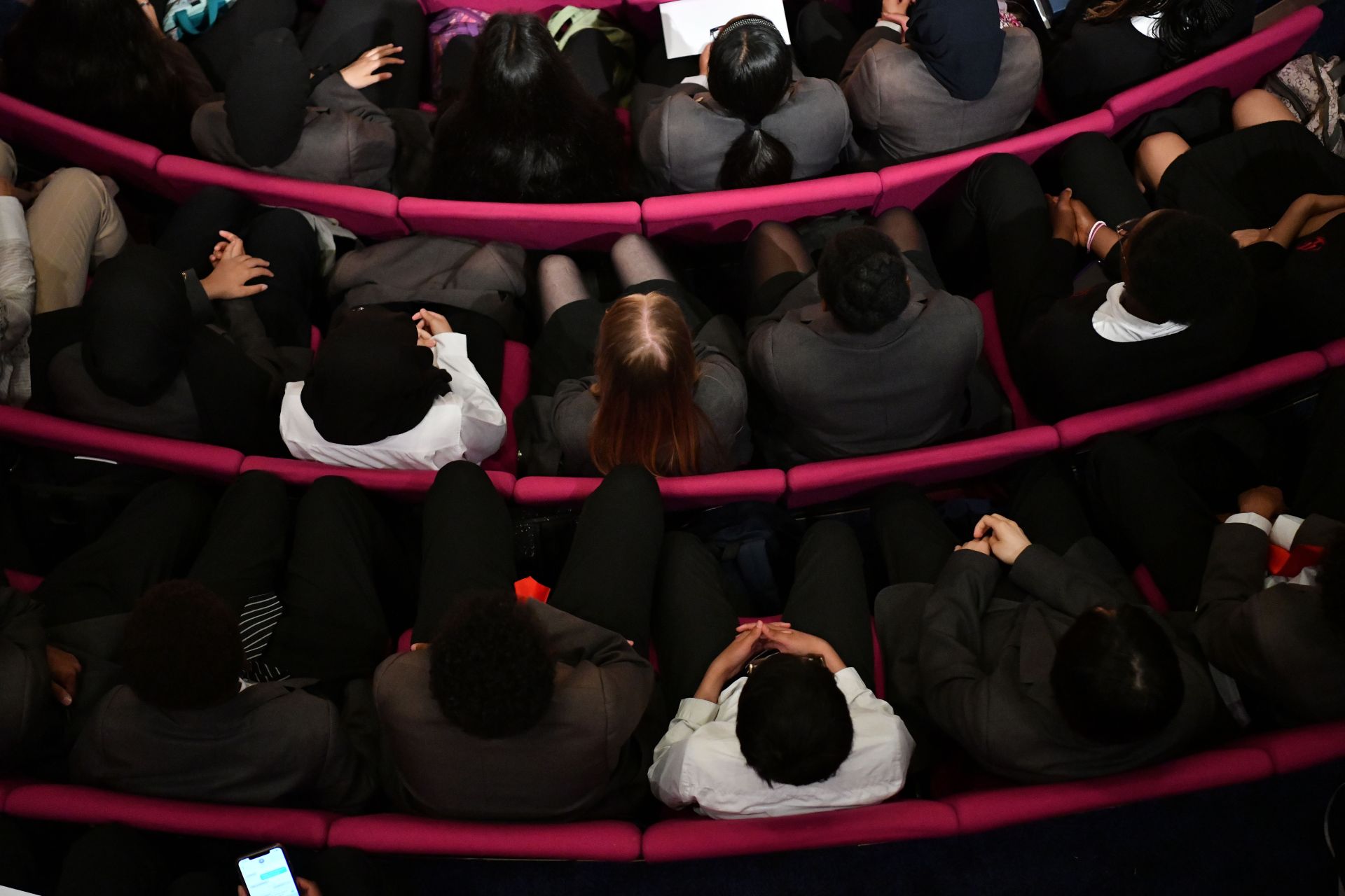 School students sitting in a lecture hall, seen from above